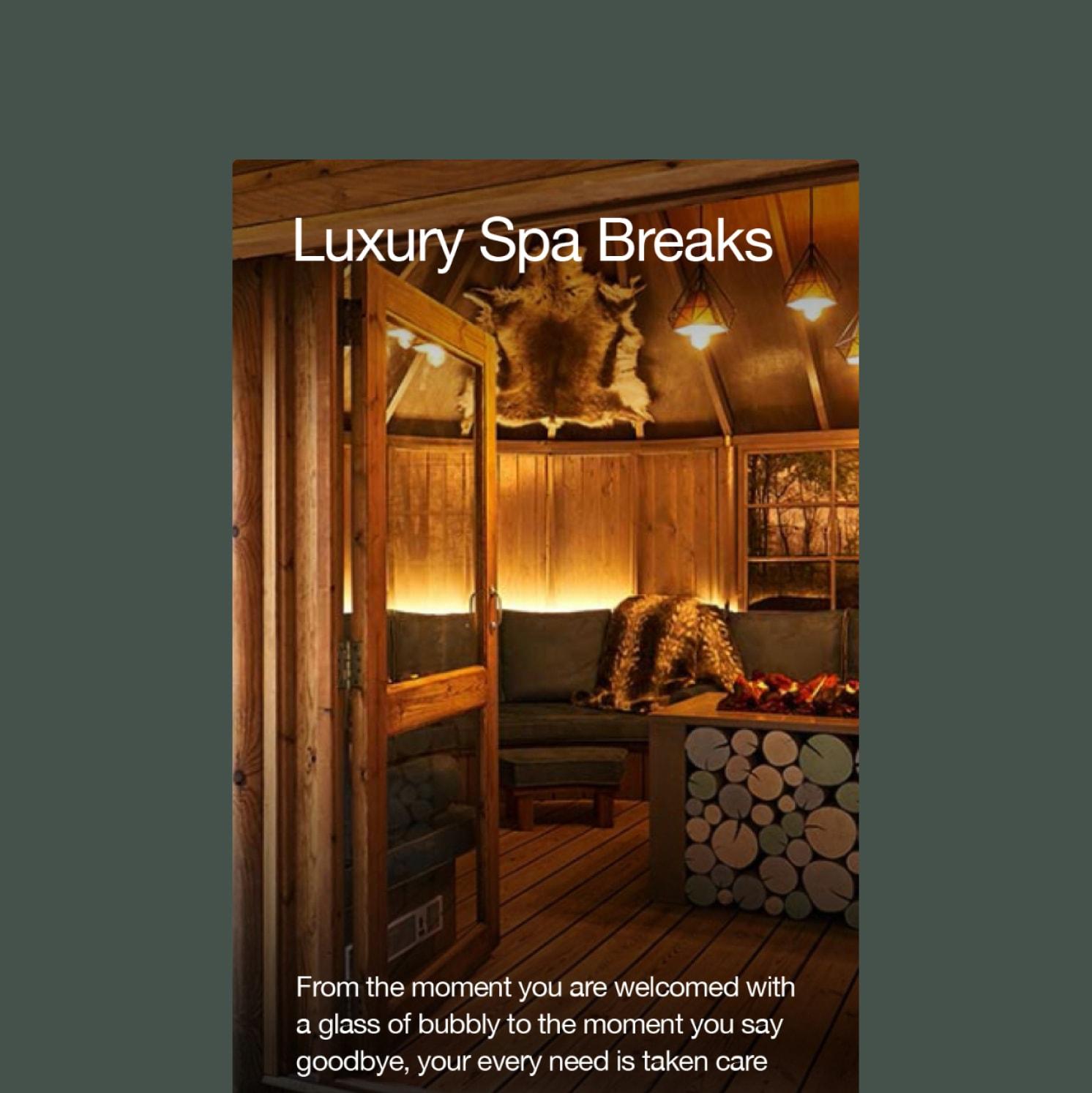 A cozy, warmly lit wooden spa room with seating, cushions, firewood, and fur decor. The text reads Luxury Spa Breaks and describes a welcoming, attentive experience.