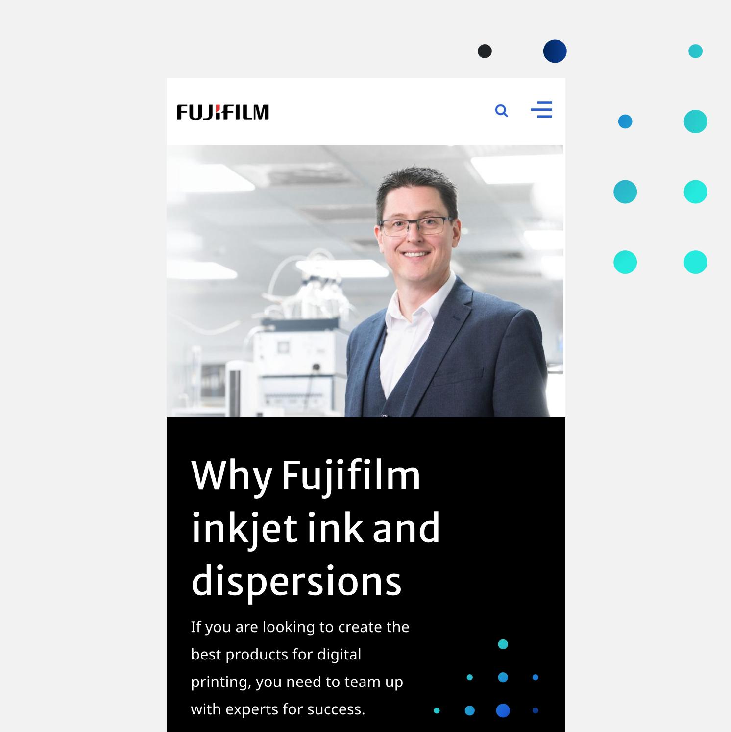 A man in a suit smiles at the camera in a modern, bright industrial setting. Text on the image reads: Why Fujifilm inkjet ink and dispersions with information about digital printing below.