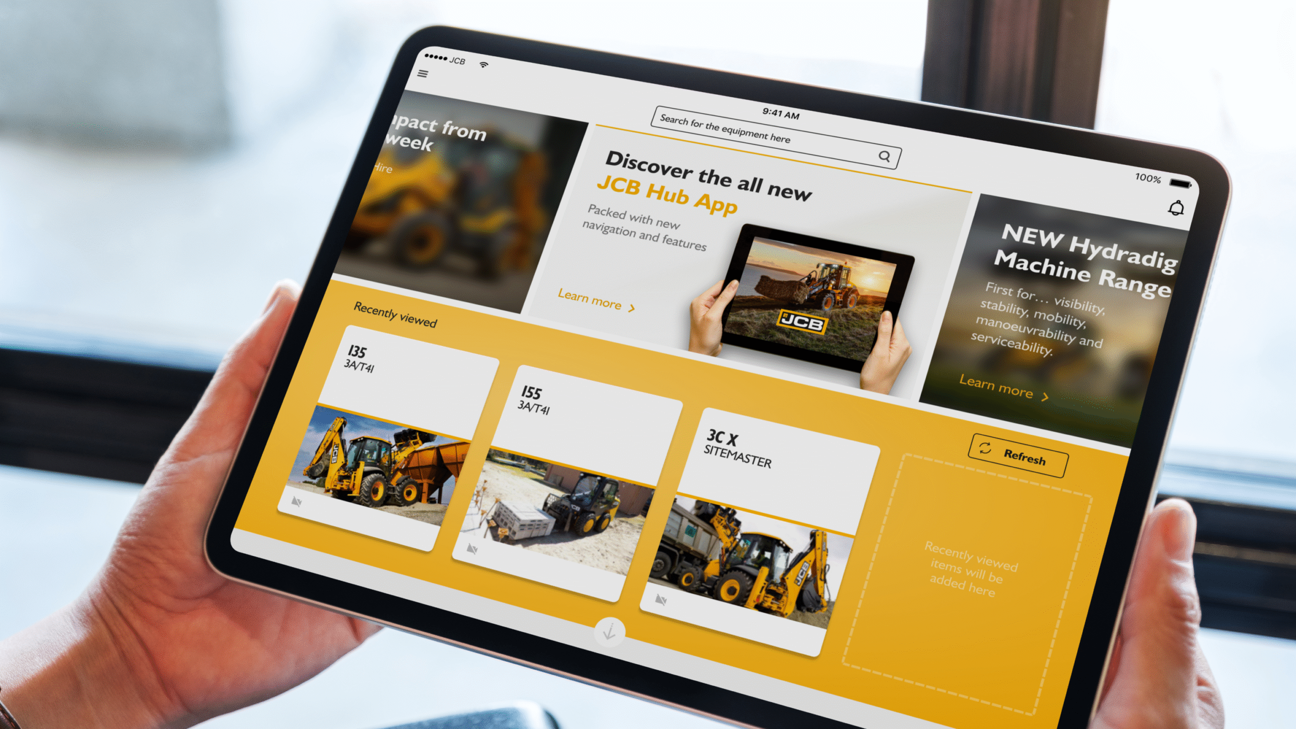 A person holds a tablet displaying a construction equipment app with images of machinery, product info, and navigation options on the screen.
