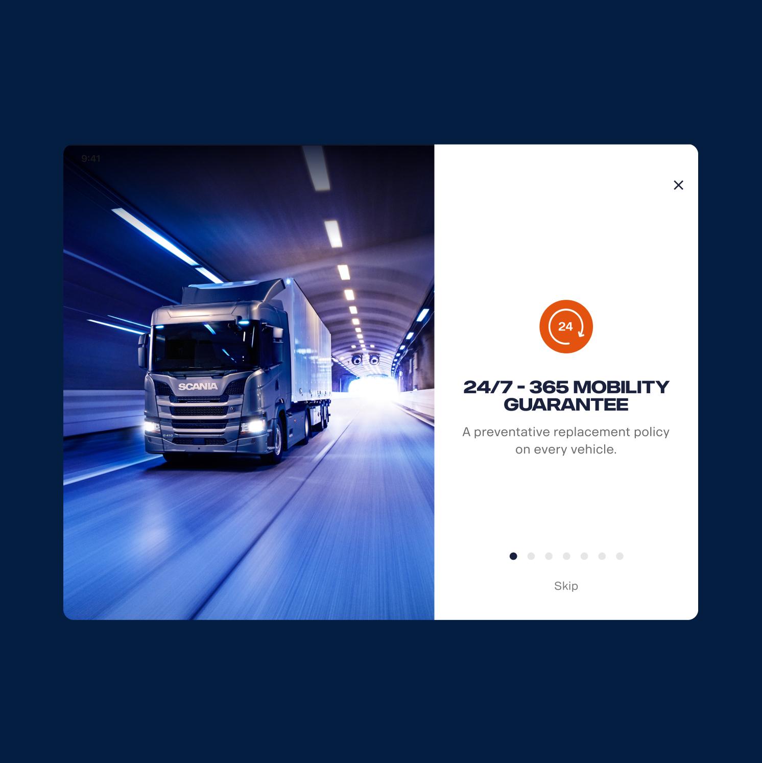 A large white truck drives quickly through a brightly lit tunnel. Next to the image, text highlights a 24/7 - 365 mobility guarantee, offering a preventative replacement policy on every vehicle.